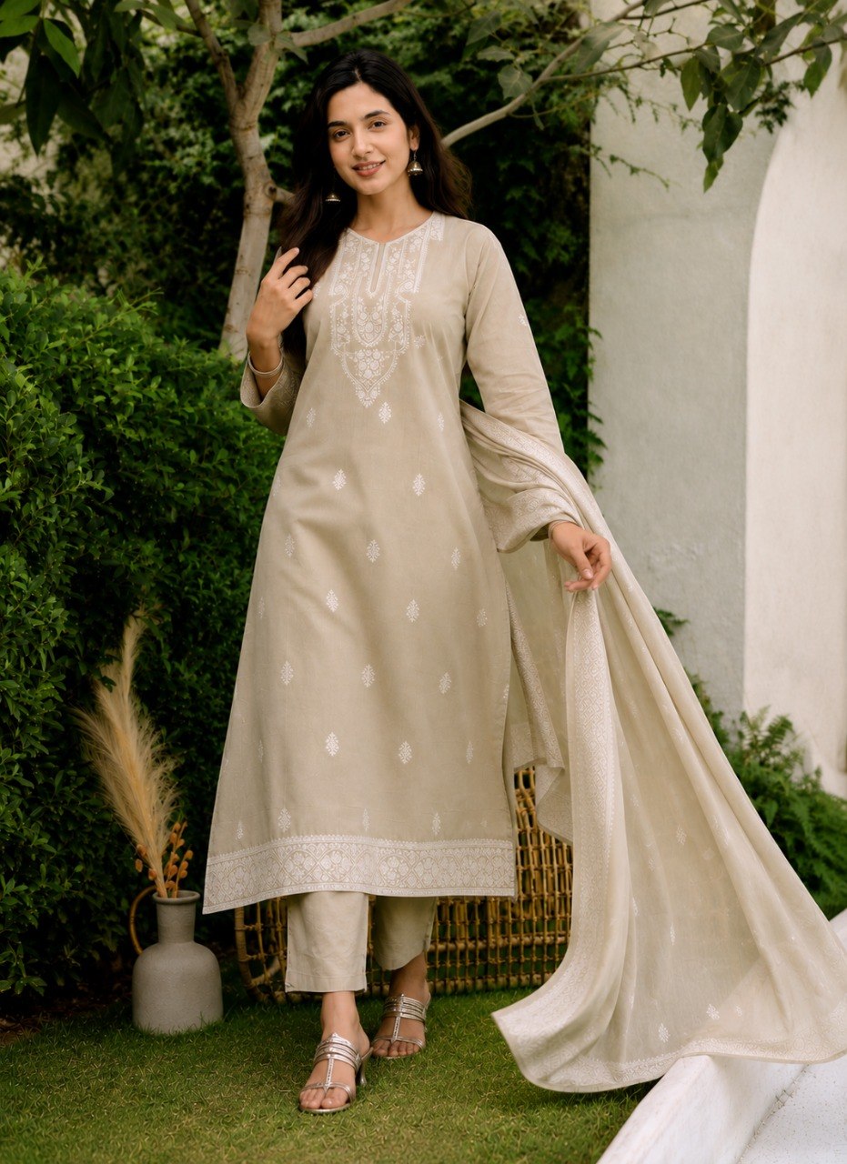 Mogra beige cotton kurta set with embroidered hem border and dupatta draped over the arm