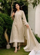 Mogra beige cotton kurta set with embroidered hem border and dupatta draped over the arm