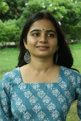 Detail of the flared bell sleeve and ivory block print on a teal blue short kurti.