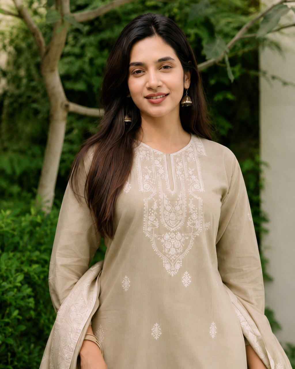 Close view of white thread flower embroidery across the yoke of the Mogra beige cotton kurta